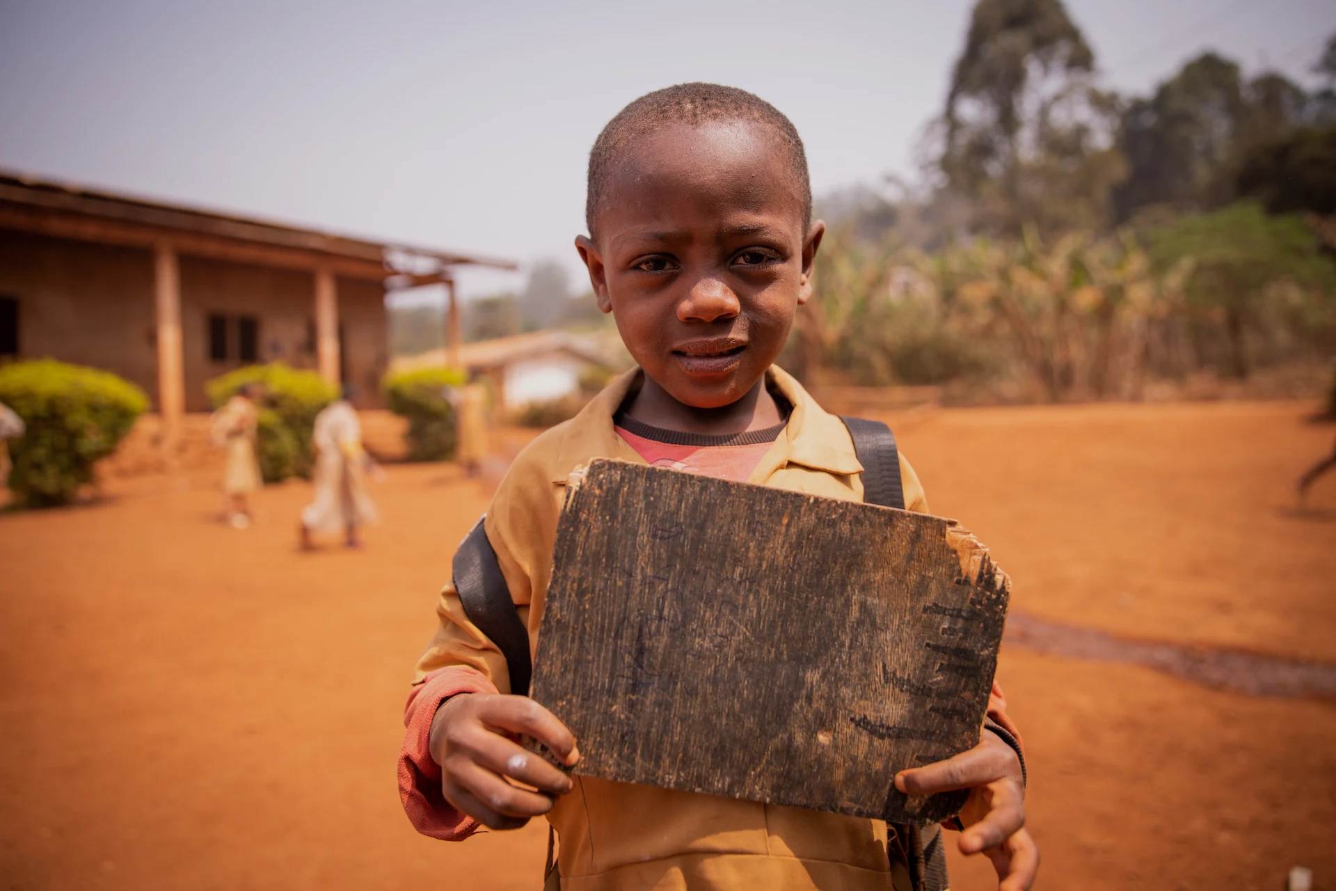 little-black-child-standing-with-his-clean-blackbo-2023-11-27-04-51-11-utc.webp